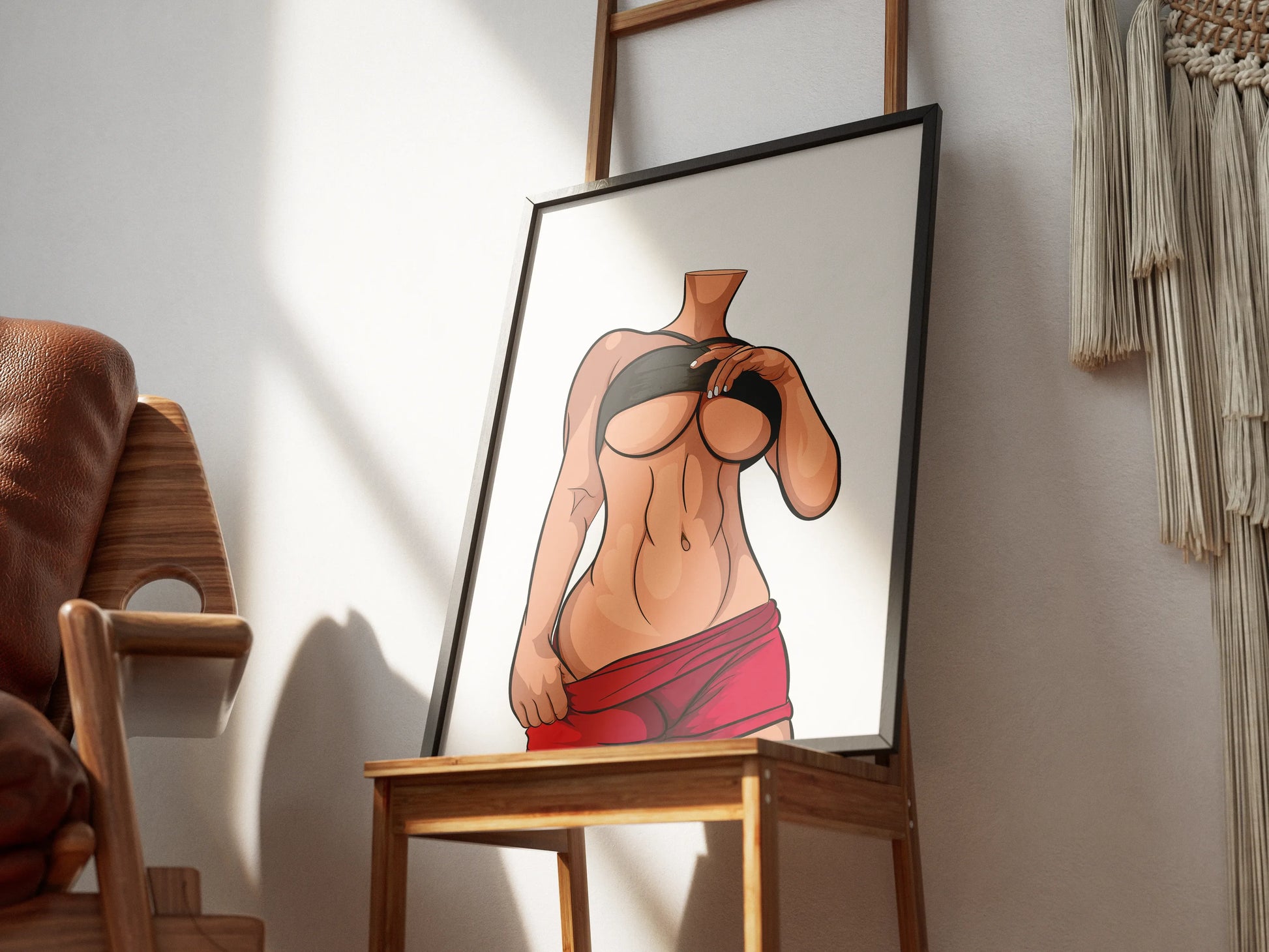 Modern digital illustration of a female figure, featuring bold lines and colors, displayed in a frame on a wooden chair.