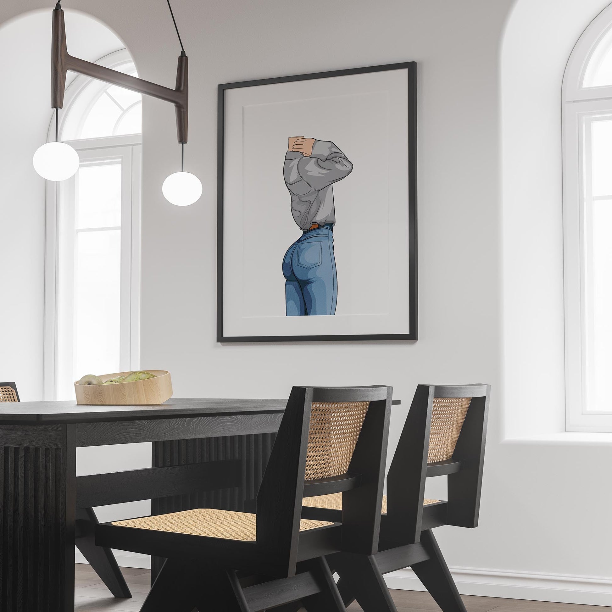 Framed art print of character in denim jeans and sweatshirt on wall above dining table.