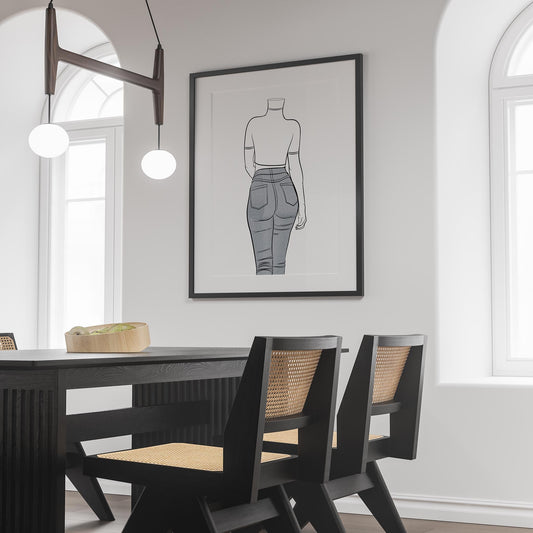 Framed pop art line drawing of a figure in jeans, modern decor setting.