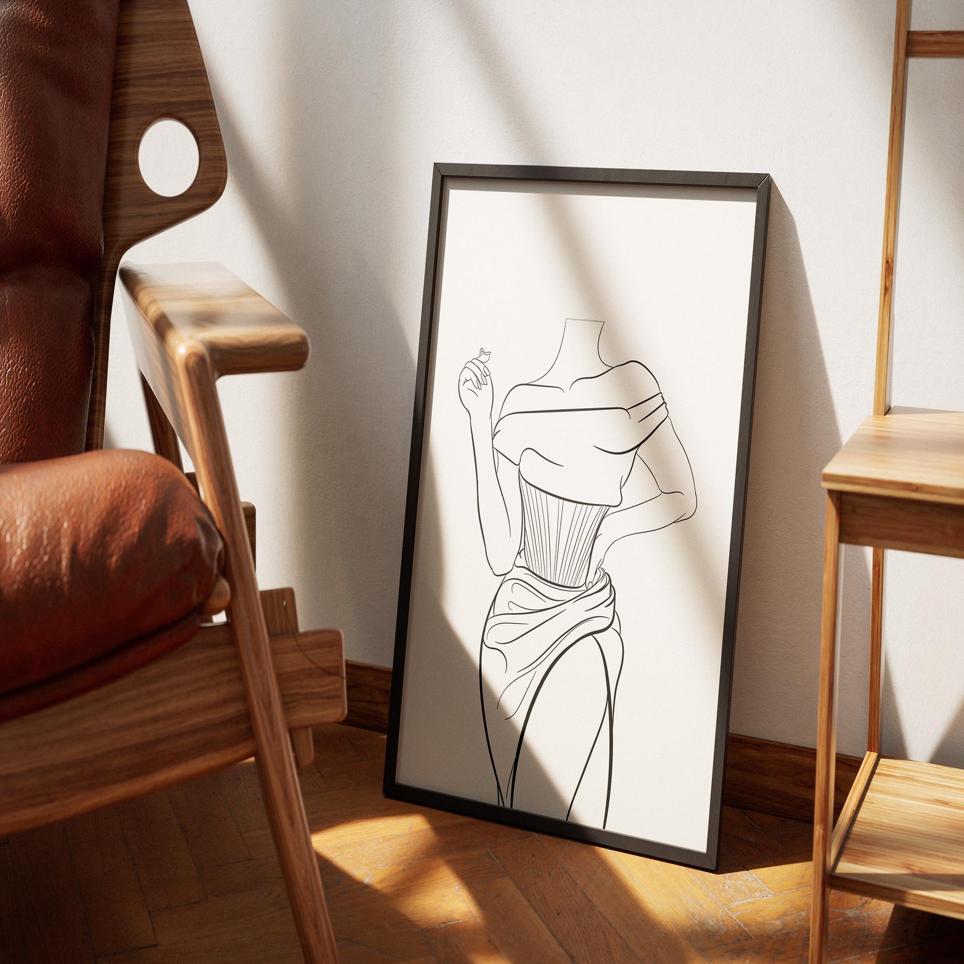 Line art of elegant corset dress framed and displayed on a wooden floor.