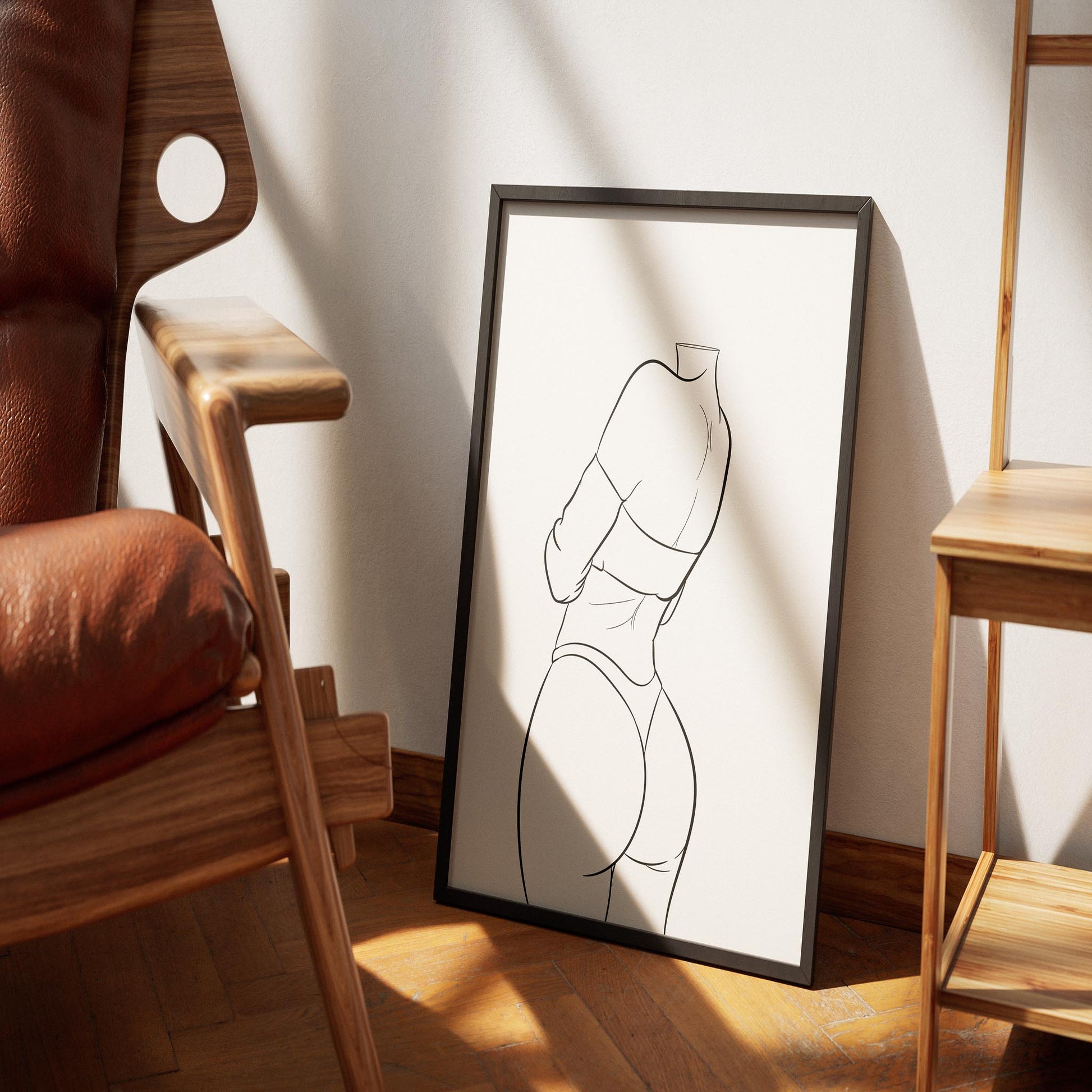 Framed line art of Model 37 featuring a minimalist silhouette, displayed on a wooden floor.