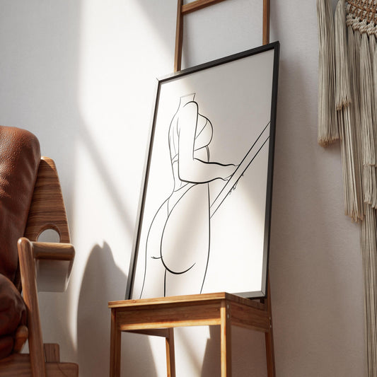 Digital artwork of curvaceous female figure, Model 7 - Line Art, framed on a wooden easel against a wall.
