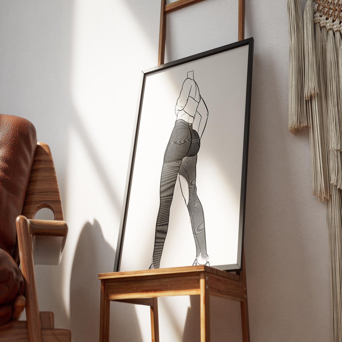 Line art illustration of model wearing high-waisted ripped jeans and tube top, framed on display.