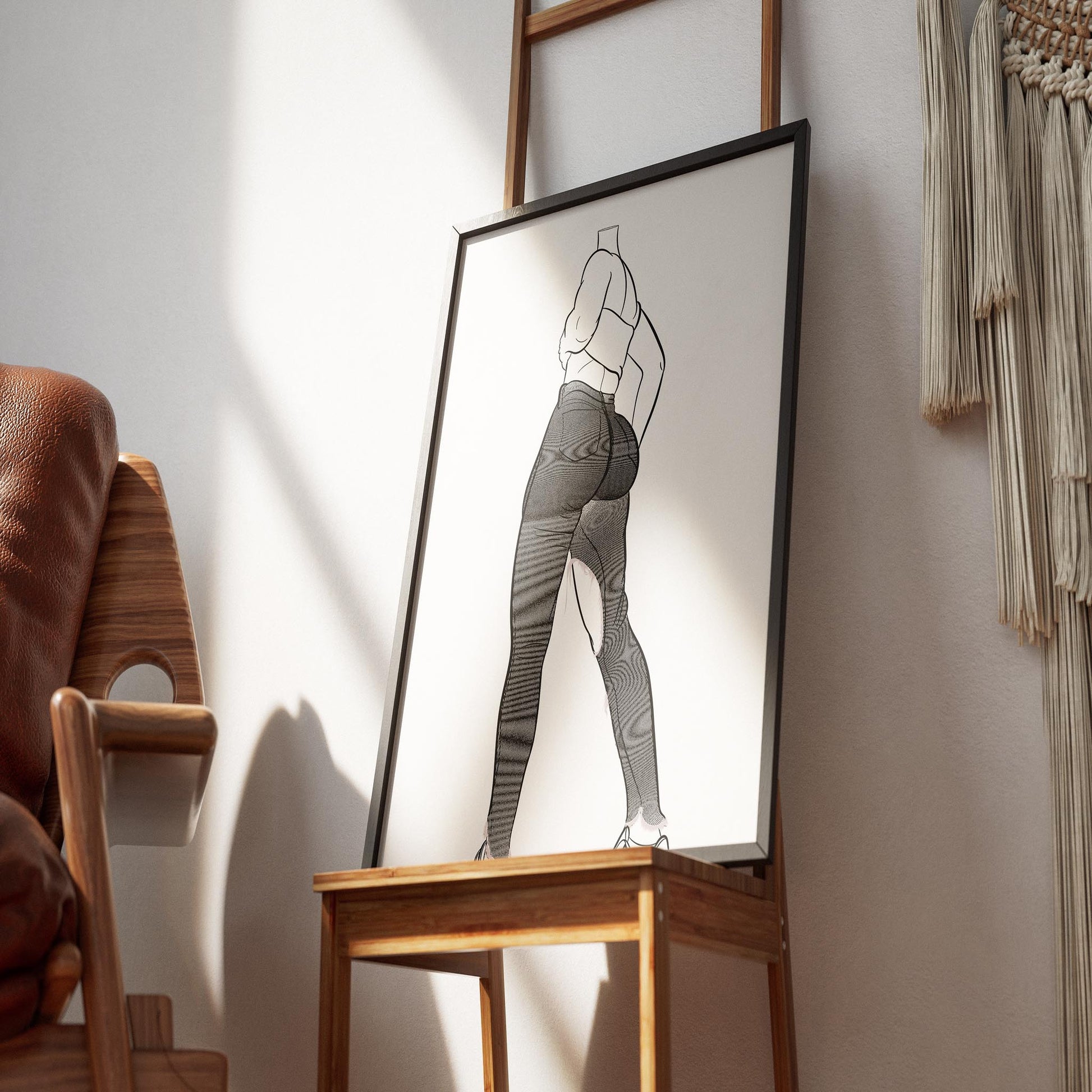 Line art illustration of model wearing high-waisted ripped jeans and tube top, framed on display.